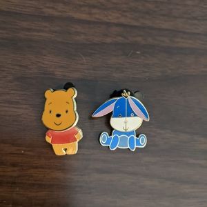 Pooh and Eeyore Disney pins.